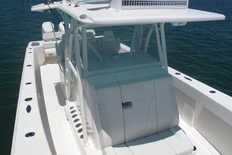 Slide: The Image of 2024 SeaVee 370z boat with sleek white design on calm water. - 11