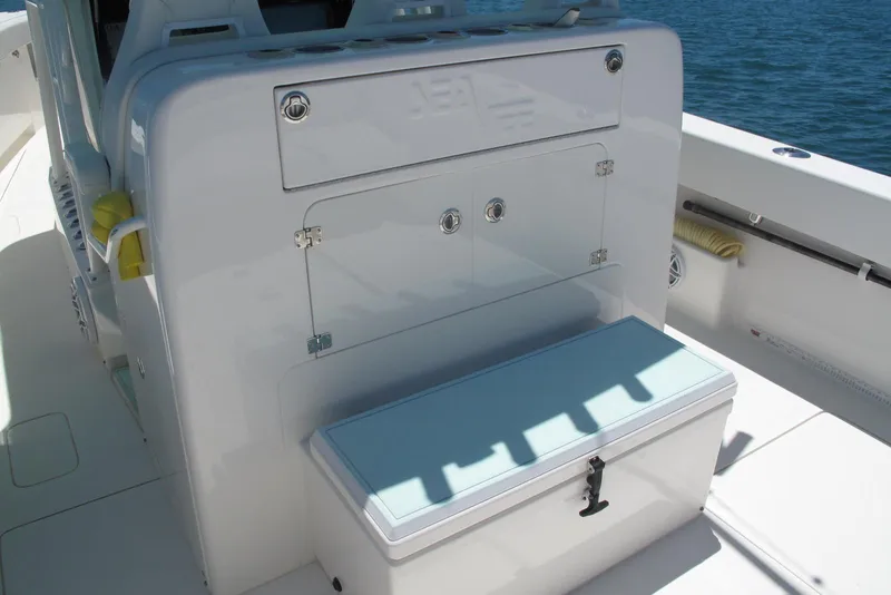 Slide: The Image of 2024 SeaVee 370z boat interior with storage compartment and seating, on calm water. - 16