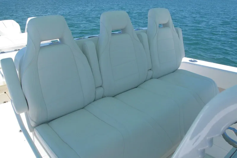 Slide: The Image of 2024 SeaVee 370z boat with luxurious white seating, ocean backdrop. - 19