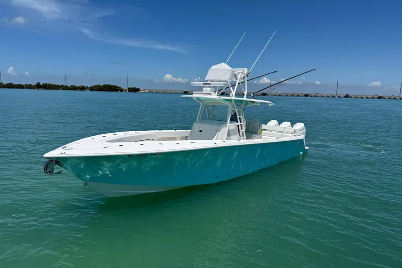 Slide: The Image of 2024 SeaVee 370z boat on calm turquoise water under clear blue sky. - 2
