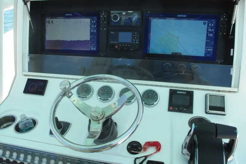 Slide: The Image of 2024 SeaVee 370z boat dashboard with navigation screens and steering wheel. - 8