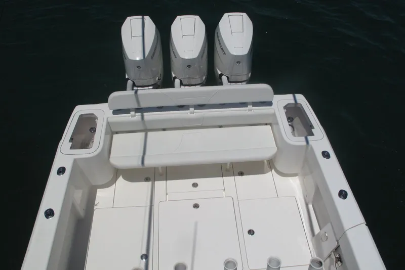 Slide: The Image of 2024 SeaVee 370z boat with triple outboard engines, spacious deck, and seating area. - 9