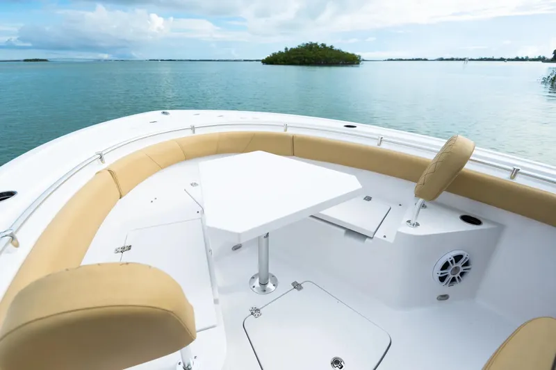 Slide: The Image of 2026 Sportsman Heritage 231 Center Console boat in showroom, featuring sleek design and modern seating. - 4