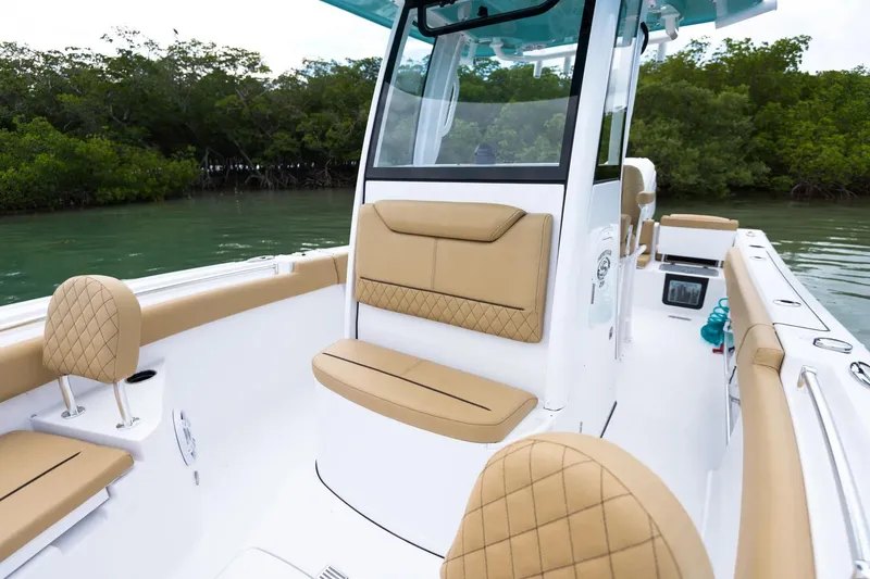 Slide: The Image of 2026 Sportsman Heritage 231 Center Console boat interior with cushioned seating. - 5