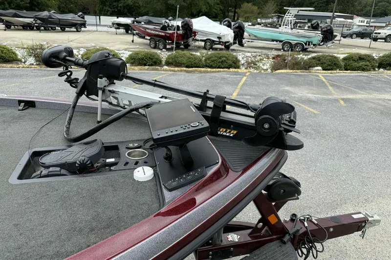 Slide: The Image of 2014 Ranger Z521 Comanche boat with advanced navigation equipment in a parking lot. - 11