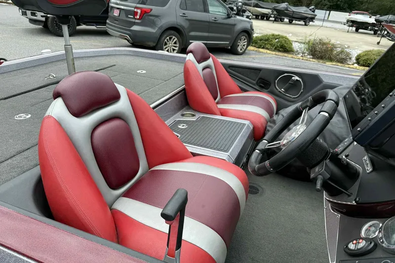 Slide: The Image of 2014 Ranger Z521 Comanche boat interior with red and gray seats, steering wheel, and console. - 8