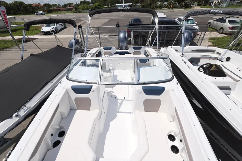 Slide: The Image of Interior of 2026 Hurricane SunDeck 2050 OB boat, featuring sleek white seating and modern design. - 12