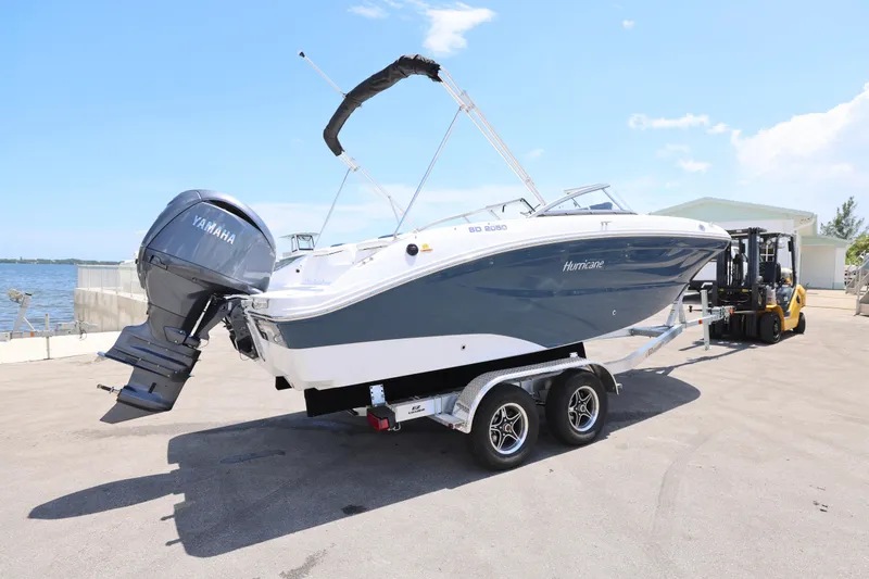 Slide: The Image of 2026 Hurricane SunDeck 2050 OB boat on trailer under a sunny sky. - 16