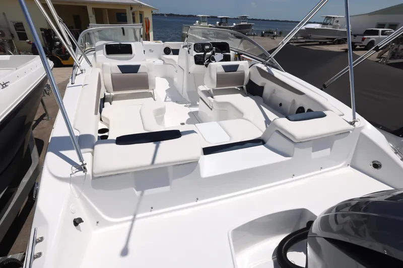 Slide: The Image of 2026 Hurricane SunDeck 2050 OB boat with spacious seating and canopy, docked near waterfront. - 18