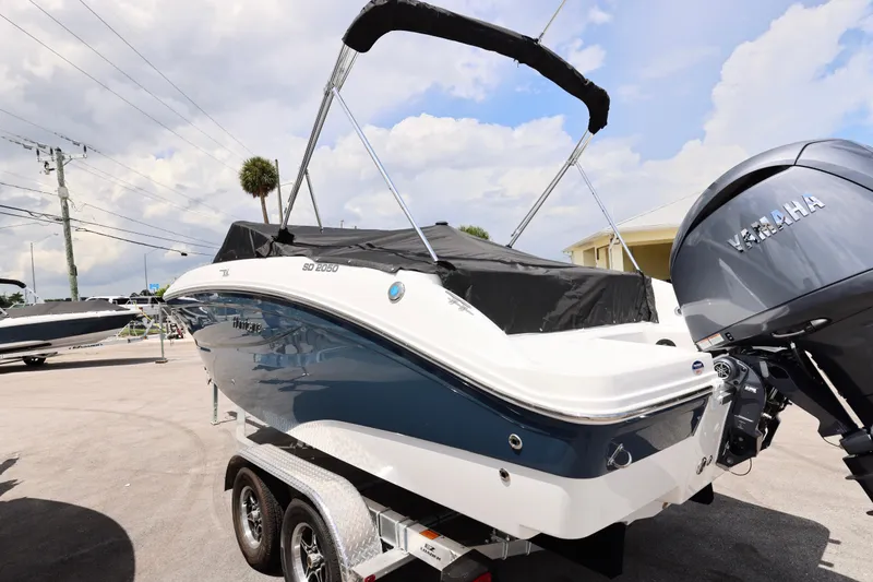 Slide: The Image of 2026 Hurricane SunDeck 2050 OB capacity label: 14 persons or 2135 lbs, 200 HP motor. - 7