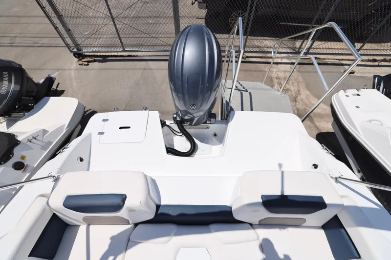 Slide: The Image of 2026 Hurricane SunDeck 2050 OB boat with Yamaha 150 engine, parked outdoors. - 9