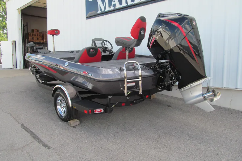 Slide: The Image of 2026 Ranger Z185 boat with powerful outboard motor, parked outside a marine facility. - 3