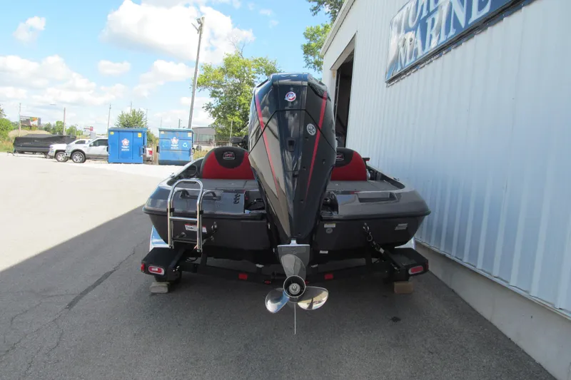 Slide: The Image of 2026 Ranger Z185 boat with outboard motor, parked outside a marine store. - 4