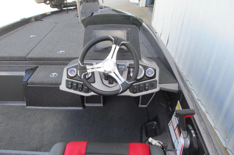 Slide: The Image of 2026 Ranger Z185 boat cockpit with steering wheel, control panel, and seating. - 6