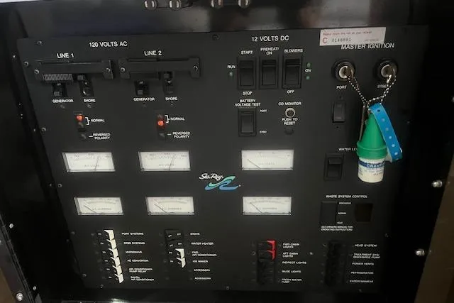 Slide: The Image of Control panel of a 1991 Sea Ray 370 Sedan Bridge boat, featuring various switches and gauges. - 12