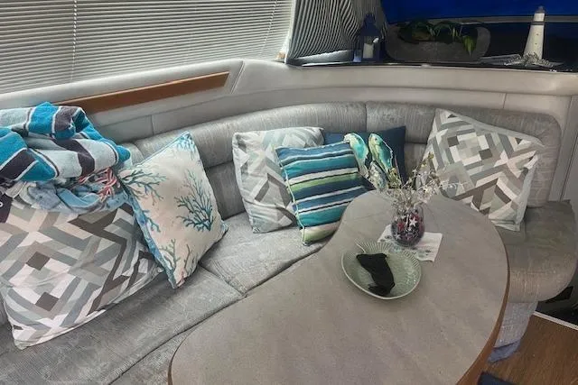 Slide: The Image of Cozy interior of 1991 Sea Ray 370 Sedan Bridge with plush seating and decorative pillows. - 13