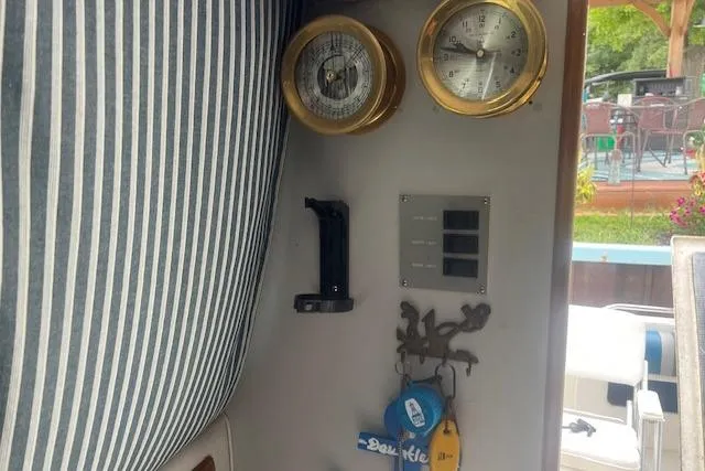 Slide: The Image of Interior of 1991 Sea Ray 370 Sedan Bridge with nautical instruments and striped upholstery. - 14