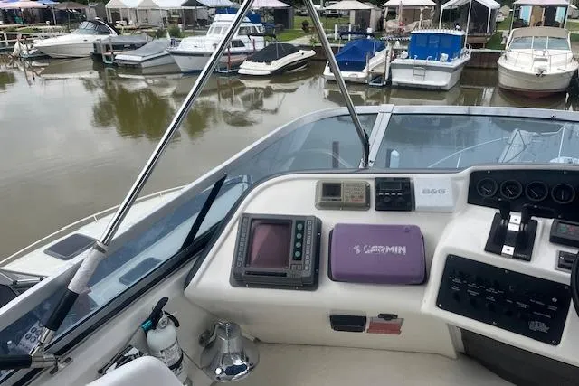 Slide: The Image of Cockpit view of a 1991 Sea Ray 370 Sedan Bridge at a marina. - 16
