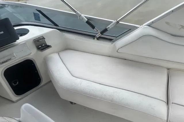 Slide: The Image of 1991 Sea Ray 370 Sedan Bridge interior with white seating and control panel. - 17