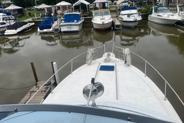 Slide: The Image of 1991 Sea Ray 370 Sedan Bridge docked among other boats in a marina. - 20