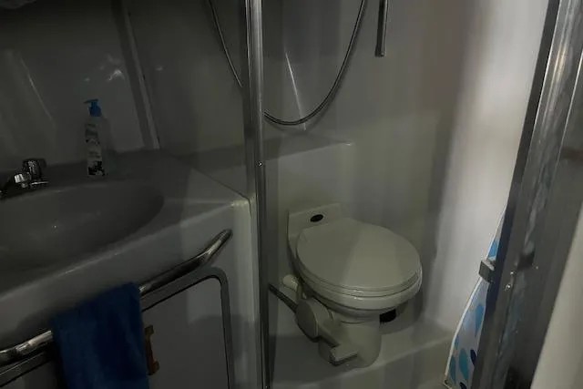 Slide: The Image of 1991 Sea Ray 370 Sedan Bridge bathroom with sink, toilet, and shower area. - 7