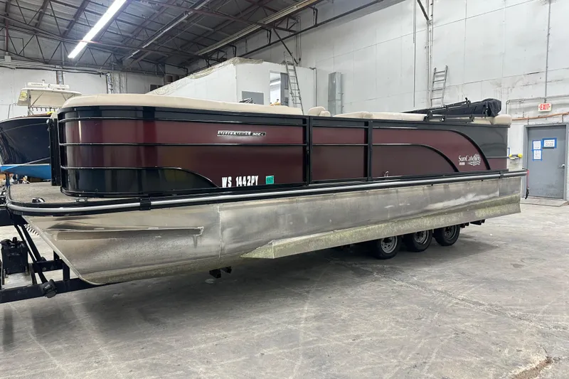 Slide: The Image of 2021 SunCatcher Select Series 322C pontoon boat in a warehouse setting. - 1