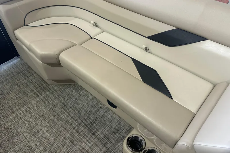 Slide: The Image of Luxurious seating on 2021 SunCatcher Select Series 322C boat, featuring beige upholstery and cup holders. - 4