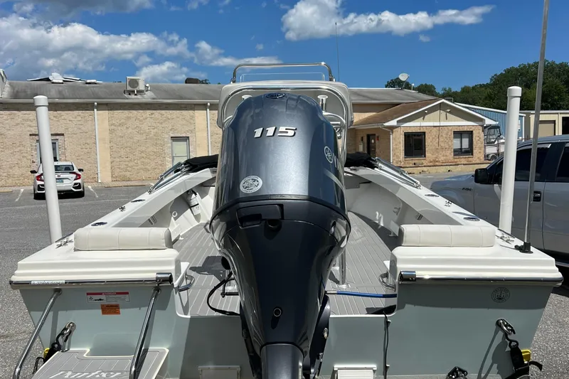 Slide: The Image of 2023 Parker 1801 Center Console boat with Yamaha 115 engine in a parking lot. - 10