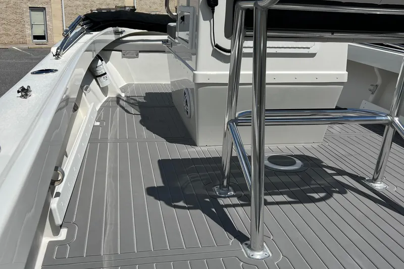 Slide: The Image of 2023 Parker 1801 Center Console boat interior with sleek gray flooring and stainless steel fixtures. - 16