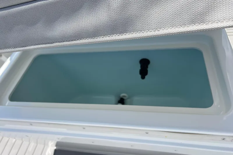 Slide: The Image of 2023 Parker 1801 Center Console boat storage compartment with open lid. - 19