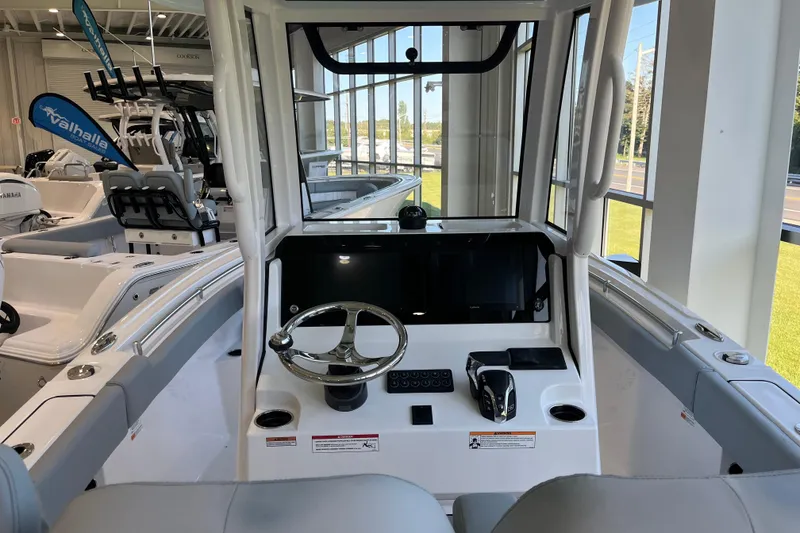 Slide: The Image of 2026 Sportsman Open 232 Center Console boat interior with steering wheel and controls. - 2