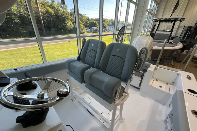 Slide: The Image of 2026 Sportsman Open 232 Center Console boat interior with dual seats and steering wheel. - 3