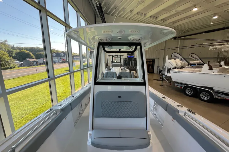 Slide: The Image of 2026 Sportsman Open 232 Center Console boat displayed in a showroom. - 4