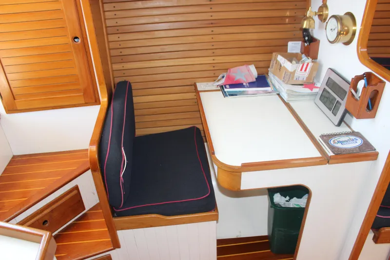 Slide: The Image of 1988 Express Yachting Scout 30 interior with wooden desk and seating area. - 11