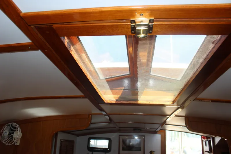 Slide: The Image of Interior view of 1988 Express Yachting Scout 30 with wooden hatch and fan. - 16