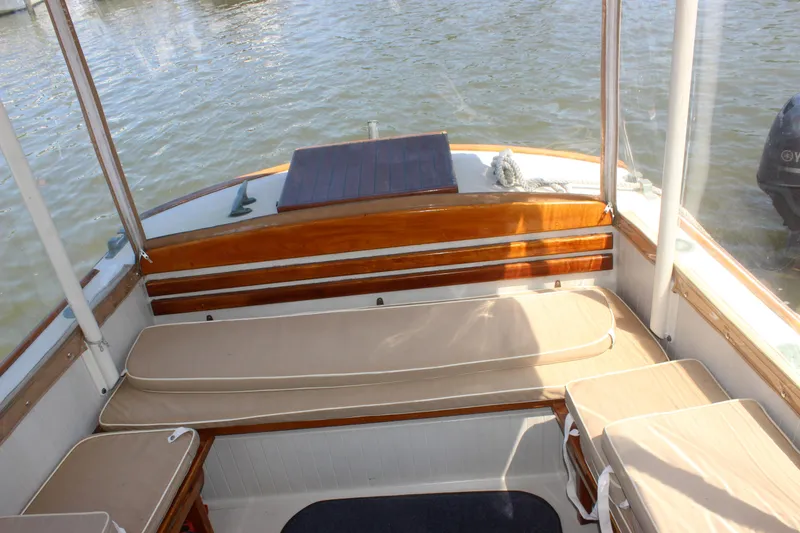 Slide: The Image of 1988 Express Yachting Scout 30 interior with cushioned seating and wooden accents. - 21