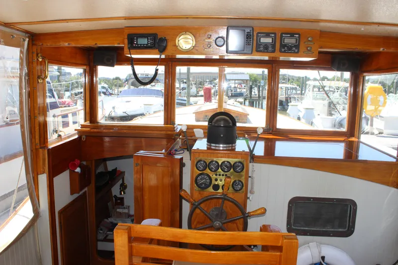 Slide: The Image of Interior view of 1988 Express Yachting Scout 30 cockpit with wooden helm and navigation instruments. - 22