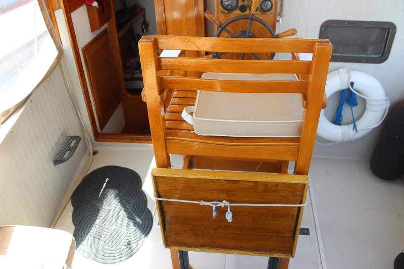 Slide: The Image of 1988 Express Yachting Scout 30 helm with wooden chair and nautical decor. - 23