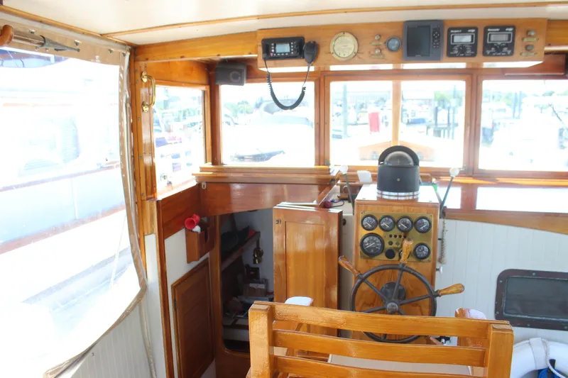 Slide: The Image of Interior of 1988 Express Yachting Scout 30, featuring wooden helm and navigation instruments. - 24