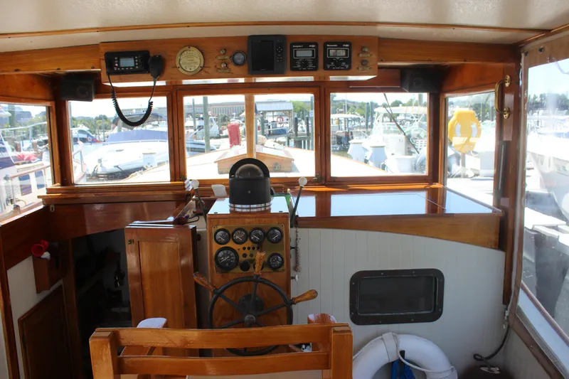 Slide: The Image of 1988 Express Yachting Scout 30 helm with wooden dashboard and marina view. - 25