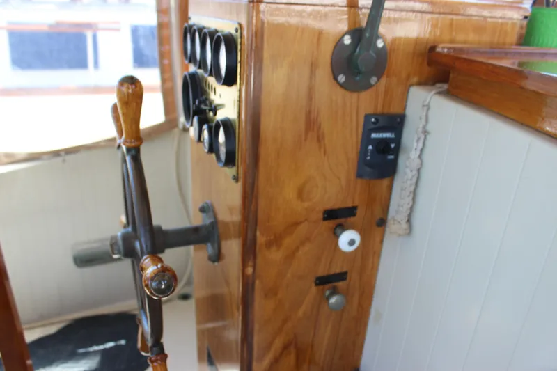 Slide: The Image of 1988 Express Yachting Scout 30 helm with wooden steering wheel and control panel. - 26