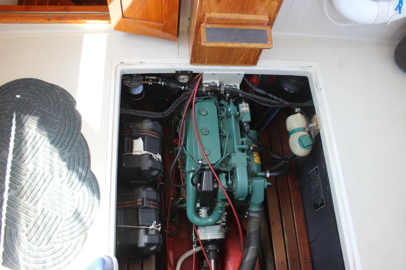 Slide: The Image of Engine compartment of 1988 Express Yachting Scout 30, showcasing marine engine and components. - 27