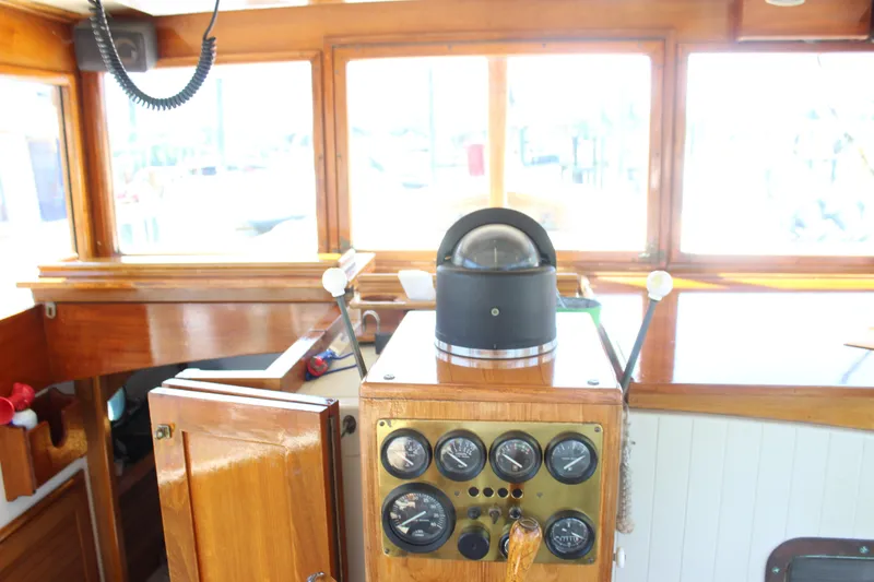 Slide: The Image of Interior helm of 1988 Express Yachting Scout 30 with wooden dashboard and navigation instruments. - 33