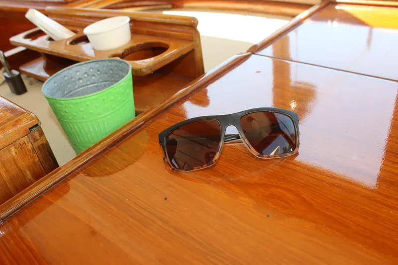 Slide: The Image of Sunglasses on polished wood surface of 1988 Express Yachting Scout 30 boat. - 35