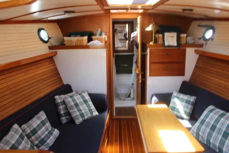 Slide: The Image of Interior of 1988 Express Yachting Scout 30 with cozy seating and wooden accents. - 36