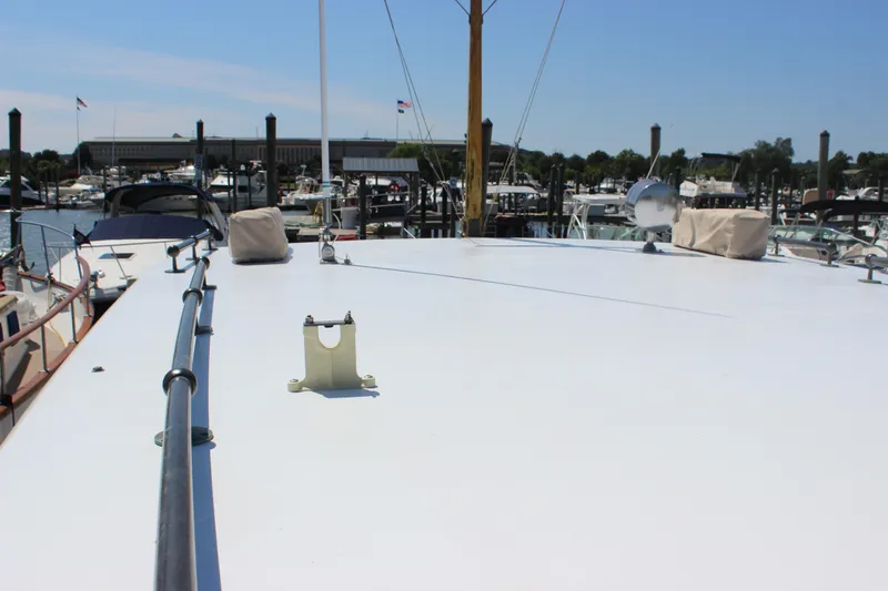 Slide: The Image of 1988 Express Yachting Scout 30 docked at marina, showcasing spacious deck. - 41