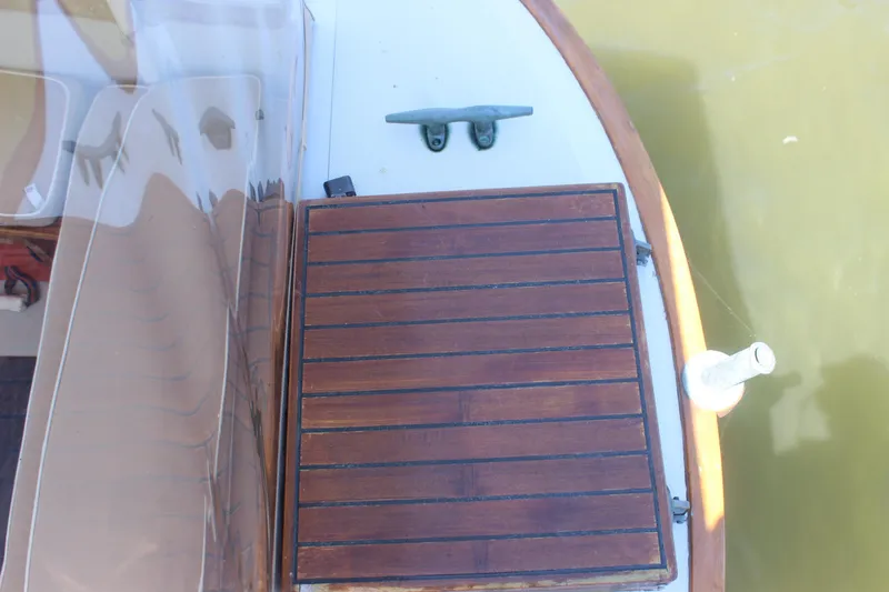 Slide: The Image of 1988 Express Yachting Scout 30 deck with wooden paneling and cleat. - 43