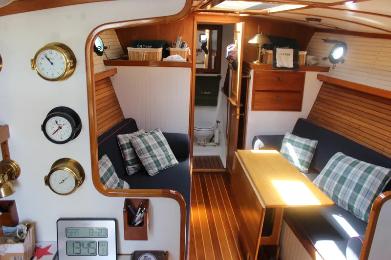 Slide: The Image of Interior of 1988 Express Yachting Scout 30, featuring cozy seating and nautical decor. - 5