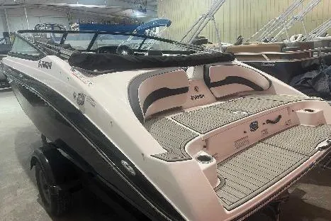 Slide: The Image of 2023 Yamaha Boats SX195, sleek design, in showroom, rear view. - 3