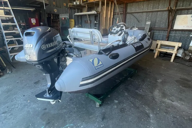 Slide: The Image of 2014 Zodiac Bayrunner 420 inflatable boat with Yamaha 40HP engine in a garage setting. - 1